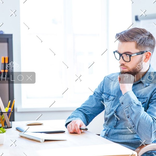 demo-attachment-115-thoughtful-designer-using-graphic-tablet-and-PSG7EPE